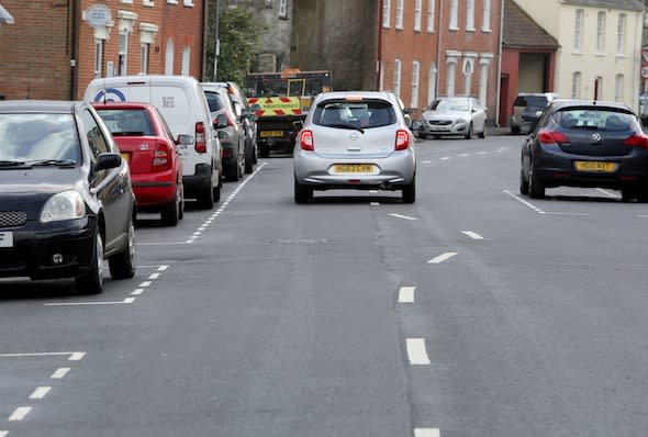 BNPS.co.uk (01202 558833)Pic: CorinMesser/BNPS***Please use full byline***At first glance it would appear the worker who painted these wonky white lines might have had one too many in the pub.Rather than the normal straight white lines running down the centre of the road, drivers are facing weird winding markings that wiggle down the carriageway.They have been baffling motorists since they appeared on a street in Wimborne, Dorset.But road chiefs insist they are deliberate, forming part of a bizarre calming measure aimed at slowing down traffic in a notorious rat run by forcing drivers to follow a curving course.