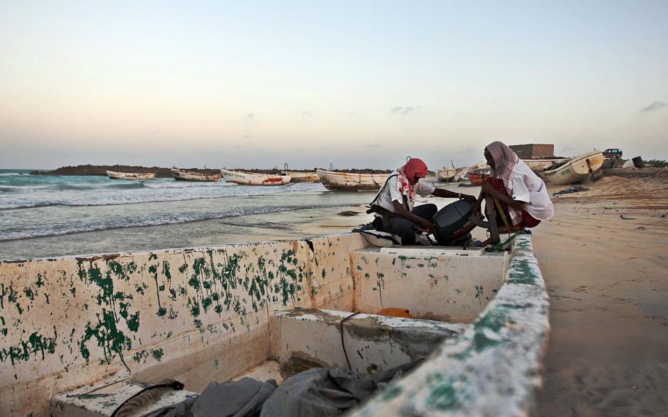 Pirates prepare a boat before going on the hunt from the pirate port of Hobyo, Somalia - AFP