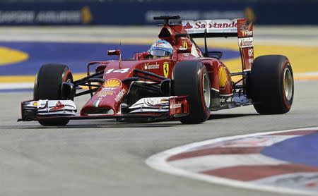 Ferrari Formula One driver Fernando Alonso of Spain takes a corner during the third practice session of the Singapore F1 Grand Prix at the Marina Bay street circuit in Singapore September 20, 2014. REUTERS/Tim Chong