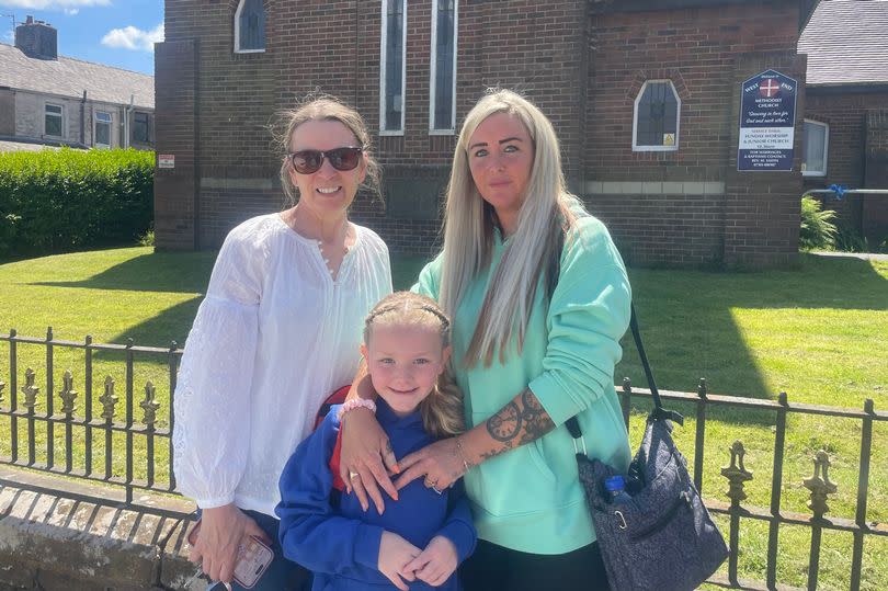 Tracy and Gemma with her daughter. They have been putting up ribbons for Jay Slater