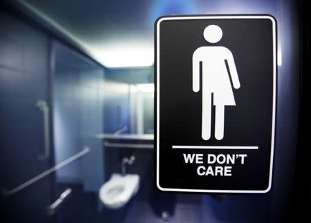 FILE PHOTO -- A sign protesting a recent North Carolina law restricting transgender bathroom access adorns the bathroom stalls at the 21C Museum Hotel in Durham, North Carolina May 3, 2016. REUTERS/Jonathan Drake/File Photo