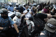 Police and protesters clash Saturday, May 30, 2020, in Philadelphia, during a demonstration over the death of George Floyd. Protests were held throughout the country over the death of Floyd, a black man who died after being restrained by Minneapolis police officers on May 25.. (AP Photo/Matt Rourke)