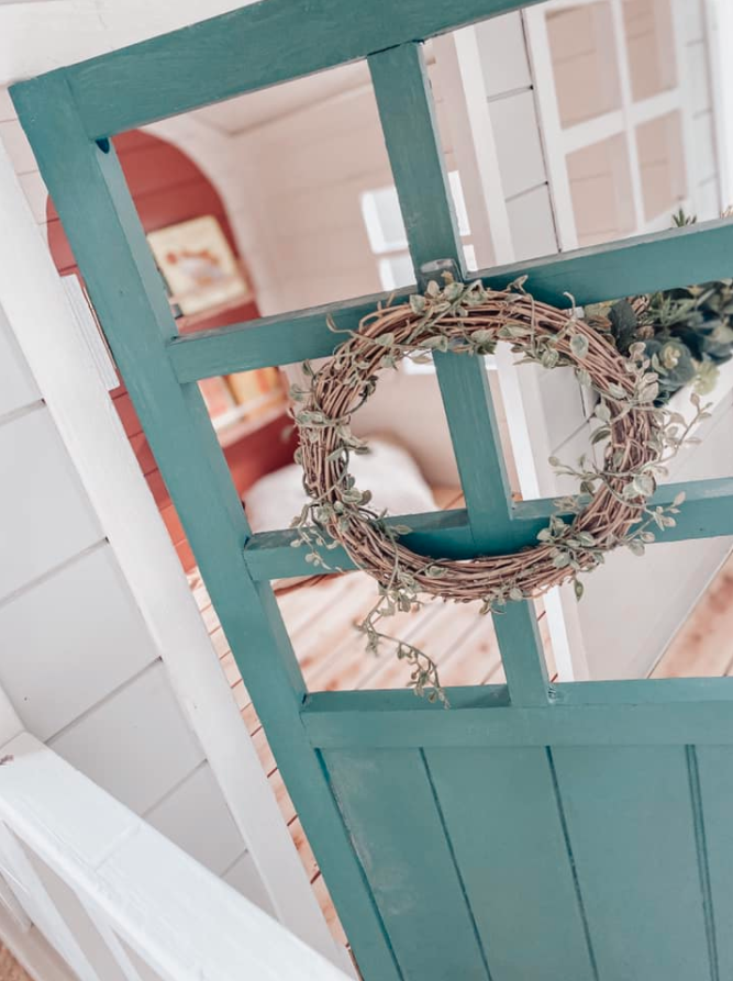 Wreath on a green door into a kid's cubby house