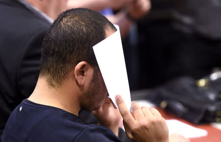 The 24-year-old Moroccan Abdederrazak Essarioul, covers his face during the initial remand hearing of suspects in the stabbing attack in Turku last week, at the Southwest Finland District Court in Turku, Finland, August 22, 2017. LEHTIKUVA / Martti Kainulainen via REUTERS