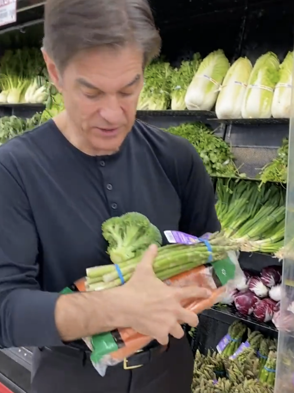 Dr. Oz at the grocery store with his arms full off veggies