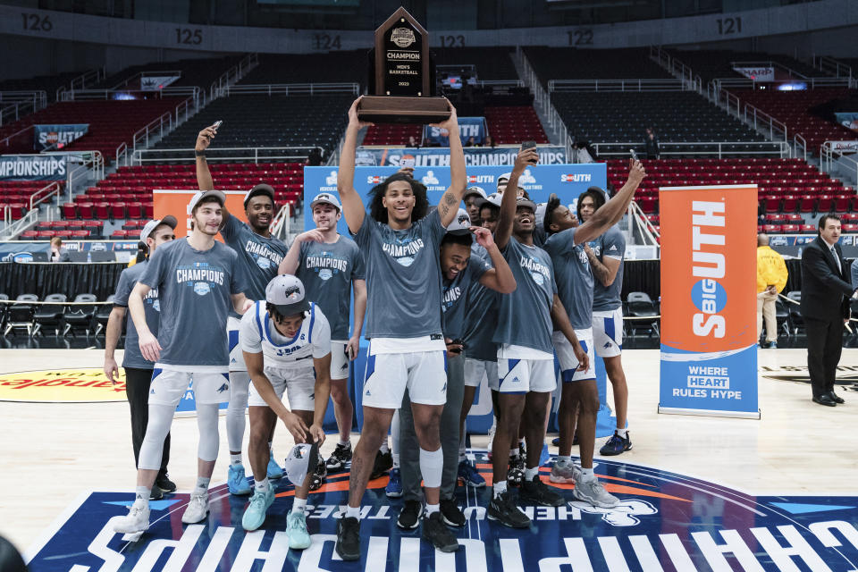 North Carolina Asheville players celebrate after defeating Campbell during the Big South Championship NCAA college basketball game on Sunday, March 5, 2023, in Charlotte, N.C. (AP Photo/Jacob Kupferman)