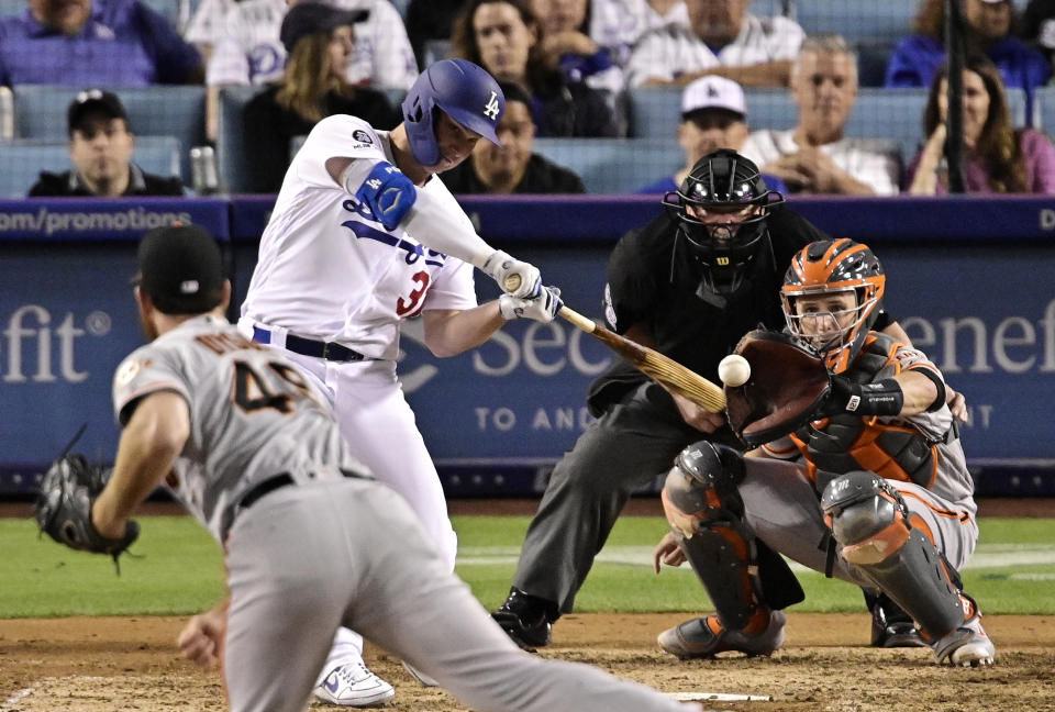Los Angeles Dodgers' Joc Pederson hits a two-run home run off San Francisco Giants relief pitcher Sam Dyson, front, during the seventh inning of a baseball game Thursday, June 20, 2019, in Los Angeles. (AP Photo/Mark J. Terrill)