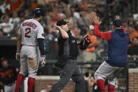 Home plate umpire Todd Tichenor, center, throws out Boston Red Sox's Xander Bogaerts, left, who argued a called third strike duirng the fourth inning of the team's baseball game against the Baltimore Orioles, Friday, Aug. 19, 2022, in Baltimore. Red Sox manager Alex Cora, right, was also ejected. (AP Photo/Gail Burton)