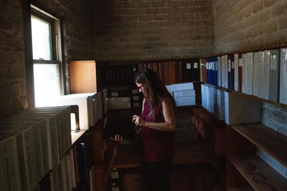 Ojai Unified School District Superintendent Sherrill Knox flips through old records stored in a side room at the district's new headquarters at Matilija Junior High School on Tuesday, July 16, 2024.