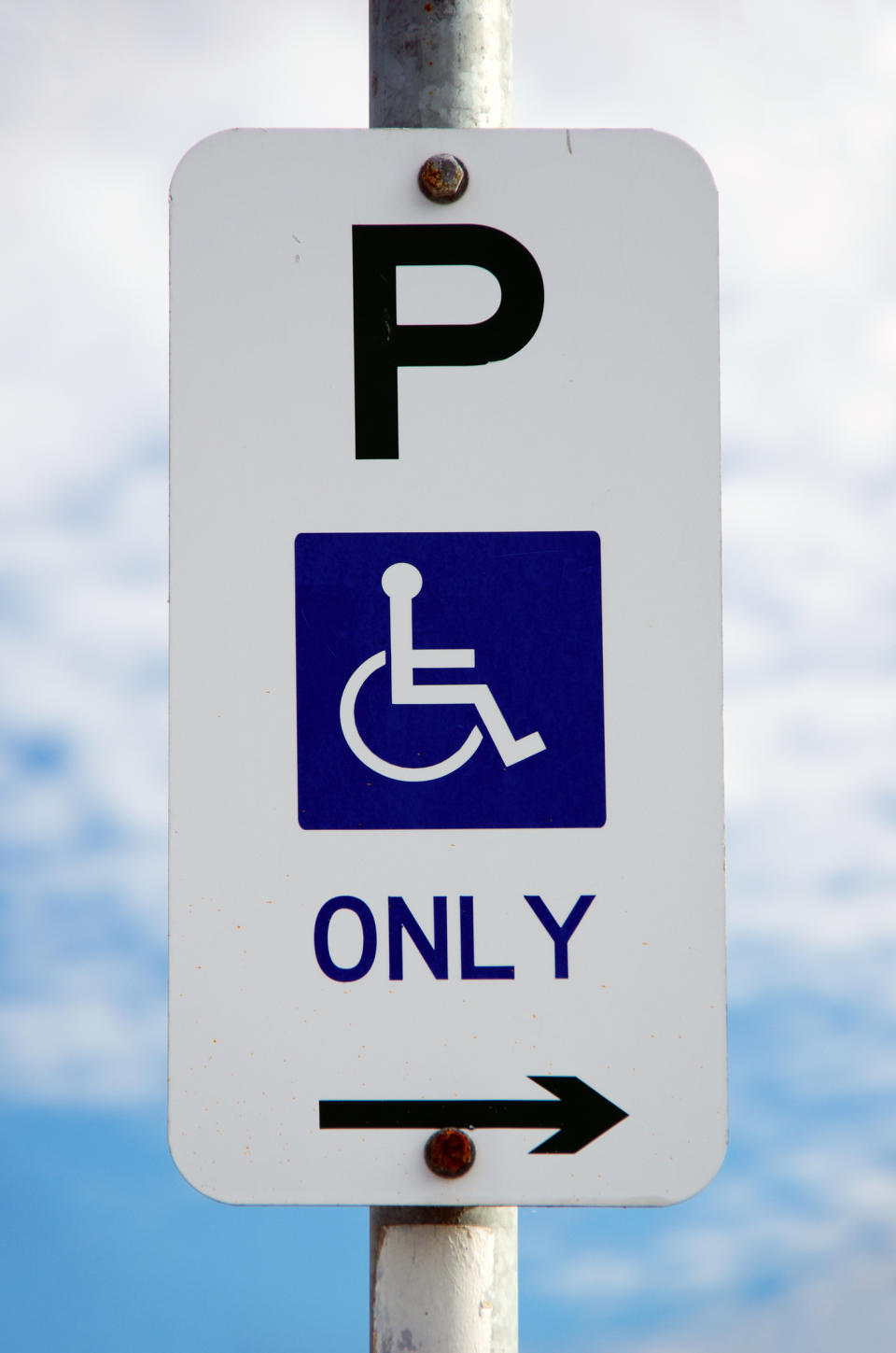 Pictured is a street sign showing it is for disabled parking only. 