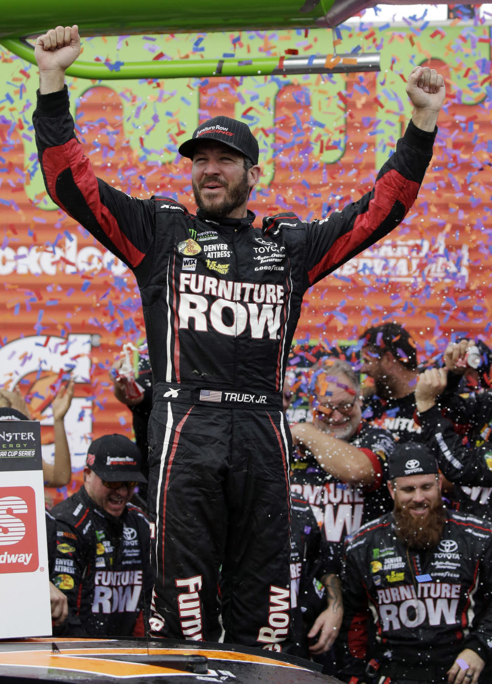 FILE - In this Sept. 17, 2017, file photo, Martin Truex Jr. celebrates with his crew in Victory Lane after winning a NASCAR Cup Monster Energy Series auto race at Chicagoland Speedway in Joliet, Ill. Furniture Row Racing will cease operations at the end of this season, shutting its doors one year after Martin Truex Jr. won NASCAR’s championship driving for the maverick race team. Furniture Row is an anomaly in NASCAR in that it is a single-car team based in Denver, Colorado, far removed from the North Carolina hub. Team owner Barney Visser was a racing enthusiast with a vision when he launched the team in 2005 determined to do it his own way. But a lack of sponsorship for next season led Visser to make the “painful decision” to close the team. (AP Photo/Nam Y. Huh, File)