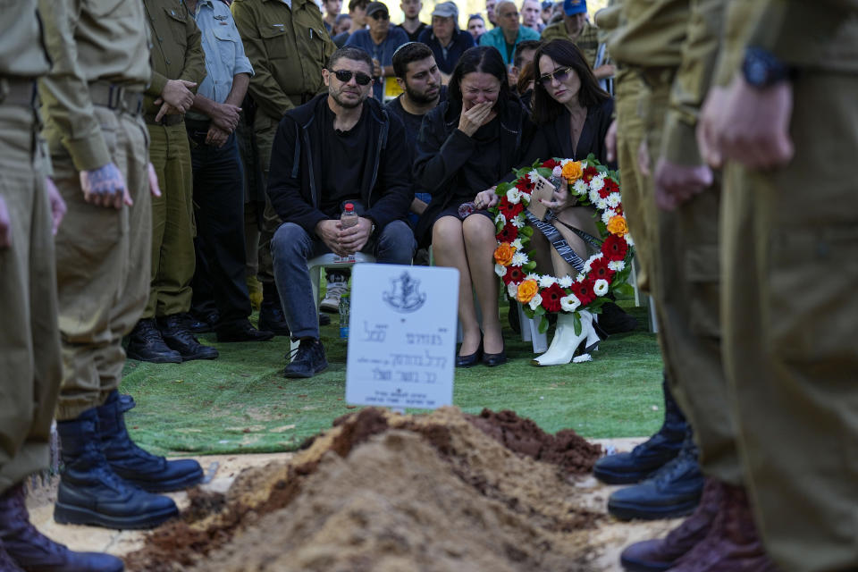 Viktor and Helena Brodski mourn during a memorial service for their son, Sgt. Kiril Brodski in the Kiryat Shaul military cemetery in Tel Aviv, Wednesday, Nov. 29, 2023. Brodski and two other soldiers, believed to have been among those killed in the initial Oct. 7 Hamas attack, were declared dead by the military Tuesday, with their remains still in Gaza. (AP Photo/Ariel Schalit)