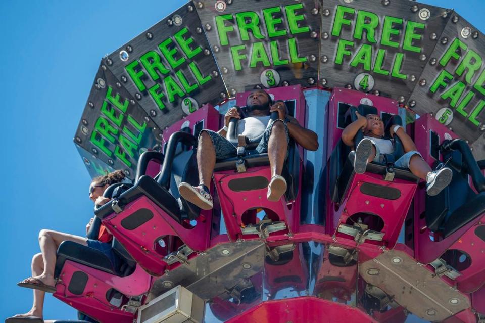 Carmelo Haskins, 9, screams as he descends on the Super Shot Drop Tower ride with his father Deandre Haskins, center, of Elk Grove, at the California State Fair on Sunday, July 17, 2022, at Cal Expo. The fair kicks off at Cal Expo in Sacramento on Friday, July 12, 2024.