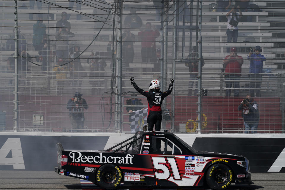 NASCAR driver Kyle Busch celebrates after he wins a NASCAR Camping World Truck Series race at Atlanta Motor Speedway on Saturday, March 20, 2021, in Hampton, Ga. (AP Photo/Brynn Anderson)