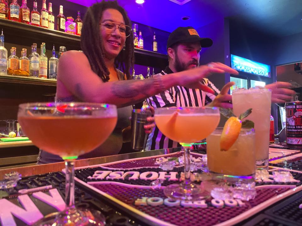 Ashley Graham puts the final garnish on the drinks prepared in the "service well" round of the Bartender Smackdown on Sunday.