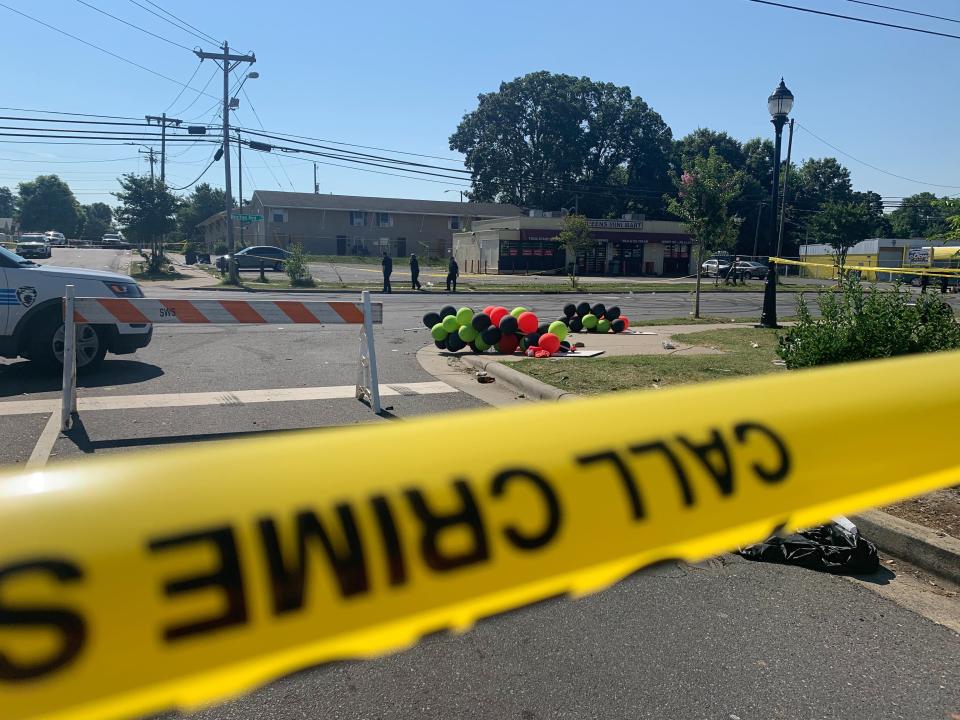 Police tape is seen near the scene of a shooting early Monday, June 22, 2020 in Charlotte, North Carolina, that resulted in two deaths and several more people wounded or injured. Police say a shooting in North Carolina's largest city has left two people dead and multiple others wounded, while several others were hit by vehicles at the scene. (AP Photo/Sarah Blake Morgan)