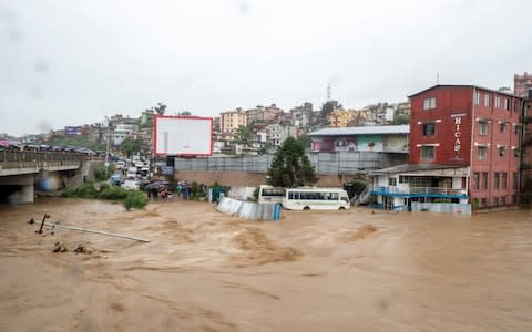 The swollen Bagmati river in Kathmandu after the heavy rain - with meteorologists warning of more problems ahead - Credit: Narendra Shrestha/Rex