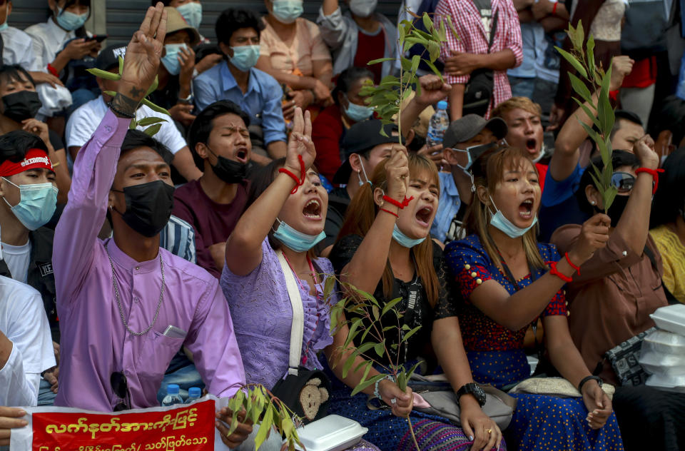 Anti-coup protesters shout slogans in Yangon, Myanmar, Thursday, Feb. 25, 2021. Social media giant Facebook announced Thursday it was banning all accounts linked to Myanmar's military as well as ads from military-controlled companies in the wake of the army's seizure of power on Feb. 1. (AP Photo)