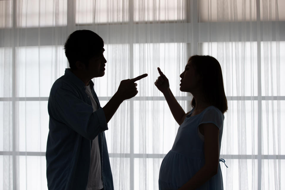 pregnant couple arguing and quarreling at home