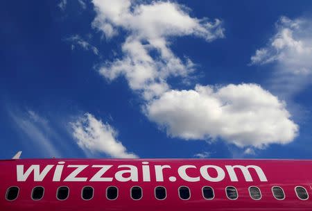 FILE PHOTO: Wizz Air's logo is seen on the side of an aircraft parked on the tarmac at Budapest Airport July 10, 2014.REUTERS/Bernadett Szabo/File Photo