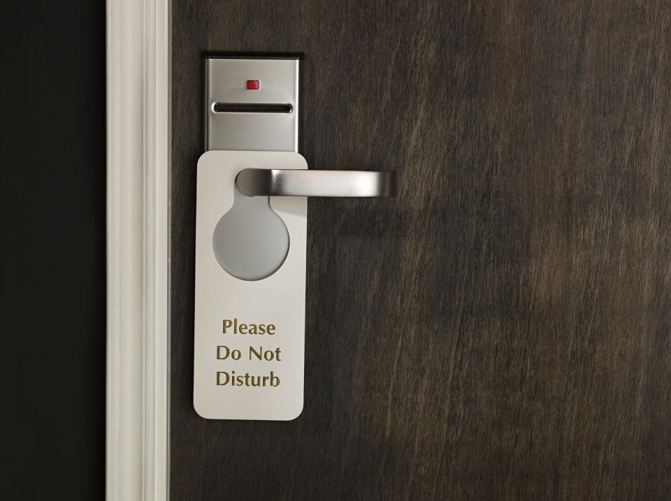 Sign on door handle reads "Please Do Not Disturb"