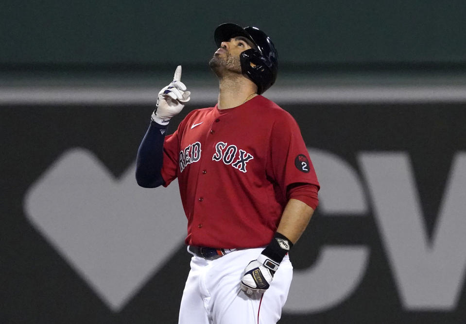 Boston Red Sox's J.D. Martinez gestures after hitting an RBI double against the Baltimore Orioles during the fourth inning of a baseball game at Fenway Park, Friday, May 27, 2022, in Boston. (AP Photo/Mary Schwalm)