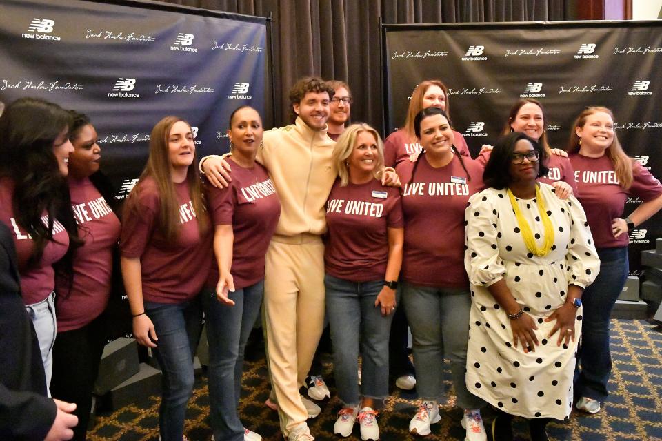 Jack Harlow poses with workers at the United Way during his shoe give away at the United Way offices, Tuesday, Nov. 28 2023 in Louisville Ky.