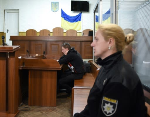 A suspected attacker on a Roma camp in Ukraine attends a court hearing June 25 near the city of Lviv. The first fatal attack on Ukraine's Roma population in years left one man dead and four more hospitalised on Saturday