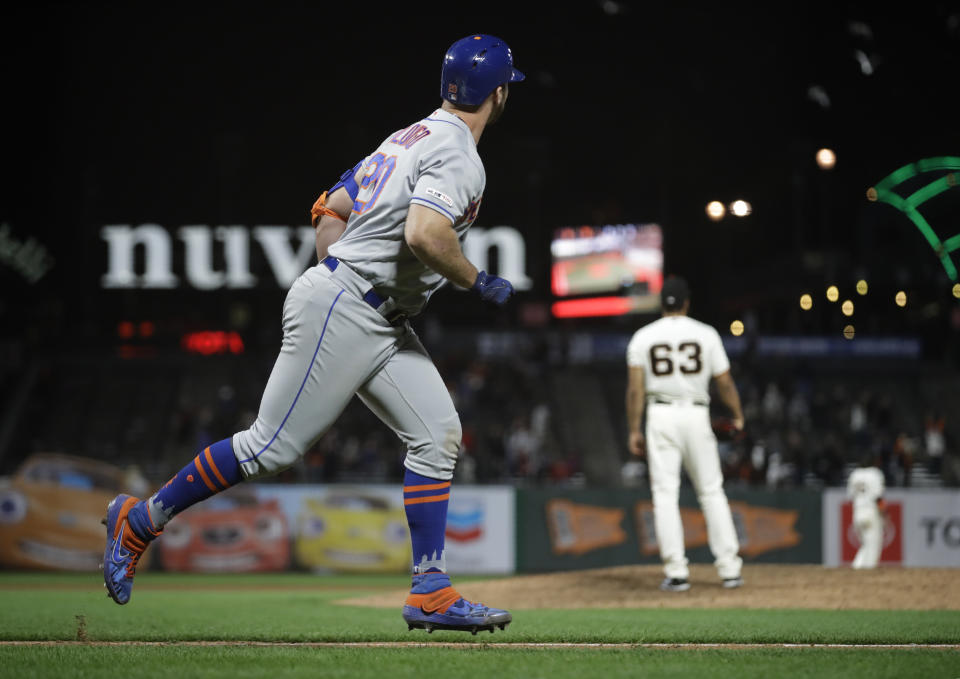 New York Mets' Pete Alonso, left, watches his home run off San Francisco Giants' Williams Jerez (63) in the 16th inning of a baseball game Thursday, July 18, 2019, in San Francisco. (AP Photo/Ben Margot)