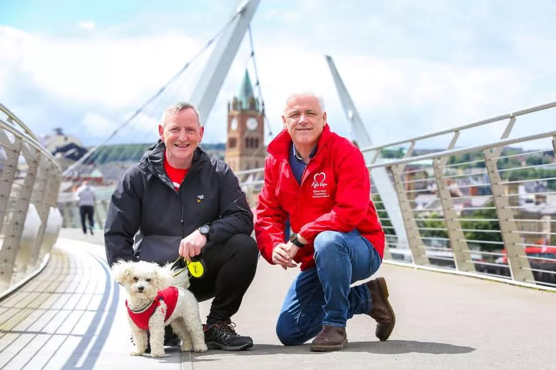 Alex Magee with his one year old walking partner, his Bichon Frise Alfie and Fearghal McKinney, head of BHF NI