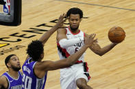 Portland Trail Blazers guard Rodney Hood, right, passes off against Sacramento Kings center Hassan Whiteside, second from left, during the second quarter of an NBA basketball game in Sacramento, Calif., Wednesday, Jan. 13, 2021. (AP Photo/Rich Pedroncelli)