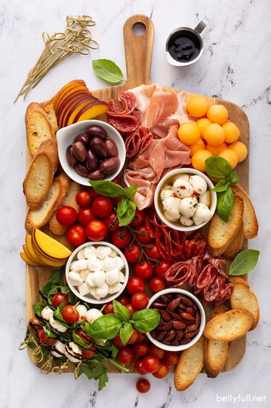 <p>Belly Full</p><p>Enjoy a simple and beautiful Italian antipasto platter with fresh fruit, cured meat, cheeses and bread. This charcuterie board is so delicious, easy to put together, and fun to eat!</p><p><strong>Get the recipe: </strong><strong><a href="https://bellyfull.net/italian-antipasto-charcuterie-board/" rel="nofollow noopener" target="_blank" data-ylk="slk:Italian Antipasto Charcuterie;elm:context_link;itc:0;sec:content-canvas" class="link rapid-noclick-resp">Italian Antipasto Charcuterie</a></strong></p>