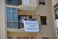 Residents in the poor Palermo neighbourhood of Brancaccio welcomed the pope who laid a wreath outside the home of murdered Father Giuseppe Puglisi