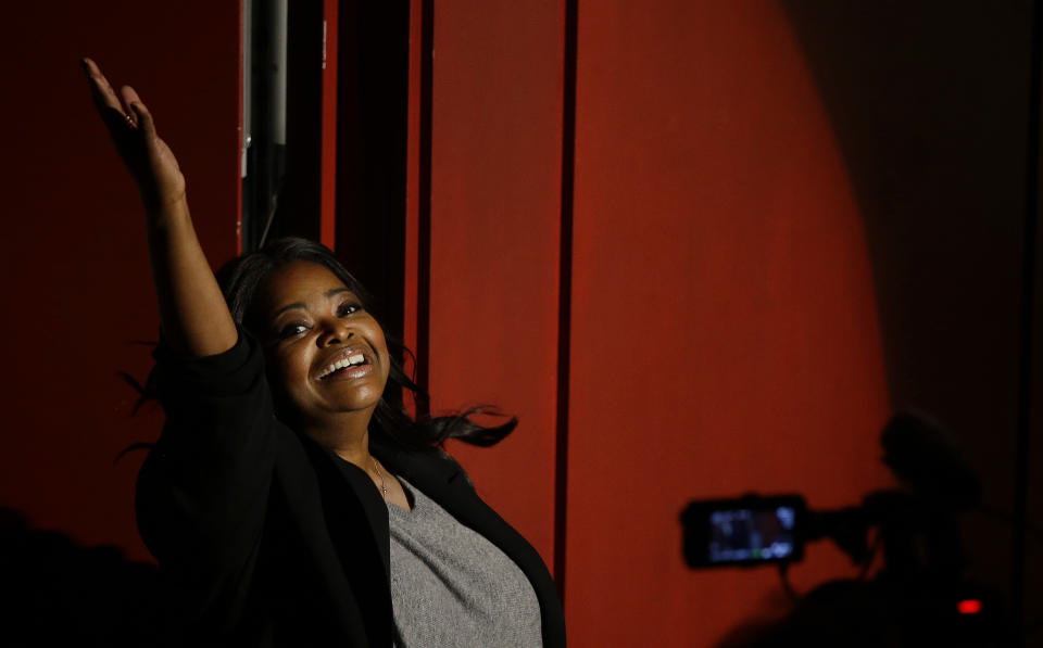 Actress Octavia Spencer acknowledges the applause of fans as she enters Farkas Hall for the presentation of the Hasty Pudding Theatricals annual Woman of the Year Pudding Pot Award Thursday, Jan. 26, 2017, in Cambridge, Mass. (AP Photo/Stephan Savoia)