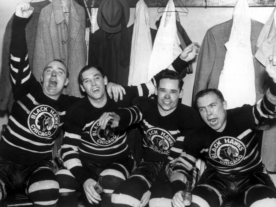 L-R) Jack Shill, Carl Voss, Cully Dahlstrom and Harold 'Mush' March of the Chicago Blackhawks celebrate in the locker room after they defeated the Toronto Maple Leafs in Game 4 of the 1938 Stanley Cup Finals on April 12, 1938 at Chicago Stadium in Chicago, Illinois. The Blackhawks defeated the Maple Leafs 4-1. (Photo by B Bennett/Getty Images)