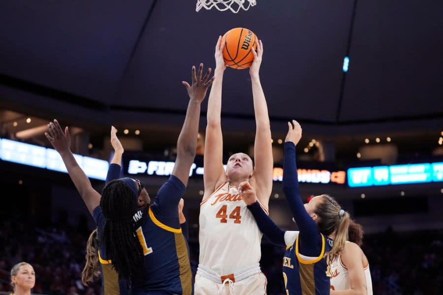 Texas forward Taylor Jones (44) grabs a rebound between Drexel forward Jasmine Valentine, left, and guard Grace O’Neill, right, during the first half of a first-round college basketball game in the women’s NCAA Tournament in Austin, Texas, Friday, March 22, 2024. (AP Photo/Eric Gay)