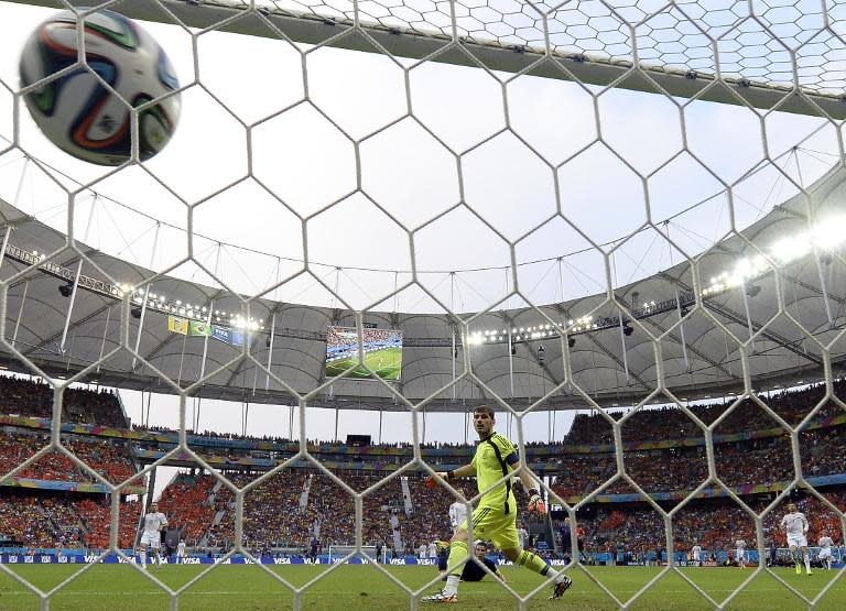 Iker Casillas (right) fails to stop a shot from Robin van Persie during the World Cup match between Spain and the Netherlands at the Fonte Nova Arena in Salvador on June 13, 2014