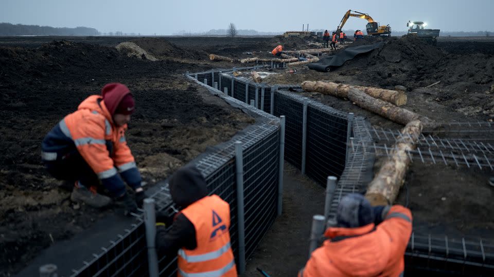 Workers inspect fortifications being built in Ukraine's Sumy region on March 16, 2024. The city of Sumy, near the border, has seen intensified attacks by Russian military groups in recent months. - Libkos/Getty Images