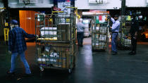 Workers unload packages and letters from mail trucks at the United States Postal Service sorting and processing facility, Thursday, Nov. 18, 2021, in Boston. Last year's holiday season was far from the most wonderful time of the year for the beleaguered U.S. Postal Service. Shippers are now gearing up for another holiday crush. (AP Photo/Charles Krupa)