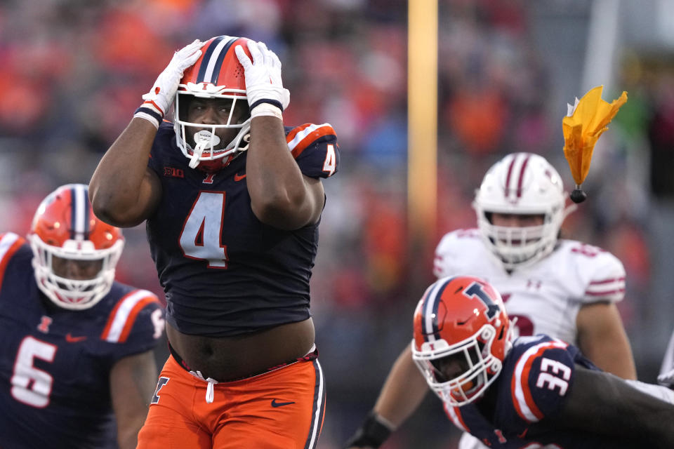 Illinois defensive lineman Jer'Zhan Newton reacts after being flagged for his hit on Wisconsin quarterback Braedyn Locke during the second half of an NCAA college football game Saturday, Oct. 21, 2023, in Champaign, Ill. Newton was called for targeting and ejected from the game. (AP Photo/Charles Rex Arbogast)
