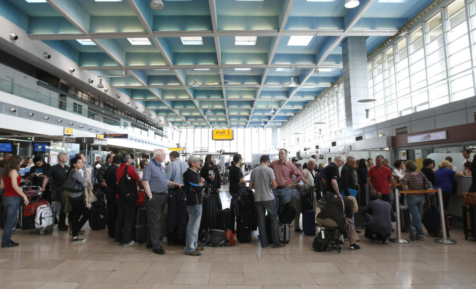 Passengers wait for a flight at Marseille-Provence Airport, in Marignane, southern France, Tuesday, June 11, 2013, as France's main airports have cut their flight timetables in half to cope with a three-day strike by air traffic controllers. The Civil Aviation Authority said that some 1,800 flights were cut Tuesday to protest against a plan to centralize control of Europe's air space. (AP Photo/Claude Paris)