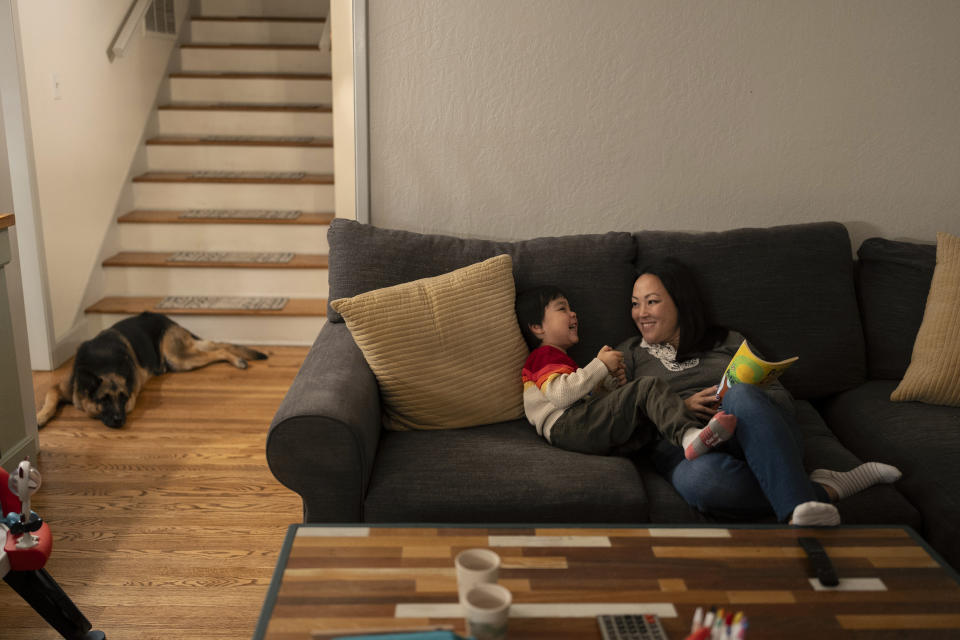 I-Ting Quinn shares a laugh with her 4-year-old son, Ethan, after dinner in Concord, Calif., Wednesday, Nov. 1, 2023. A year before Quinn's son was old enough for kindergarten, she and her husband had the option to enroll him in “transitional kindergarten” — a program offered for free by California elementary schools for some 4-year-olds. Instead, they kept Ethan in a private daycare center in Concord at a cost of $400 a week. (AP Photo/Jae C. Hong)