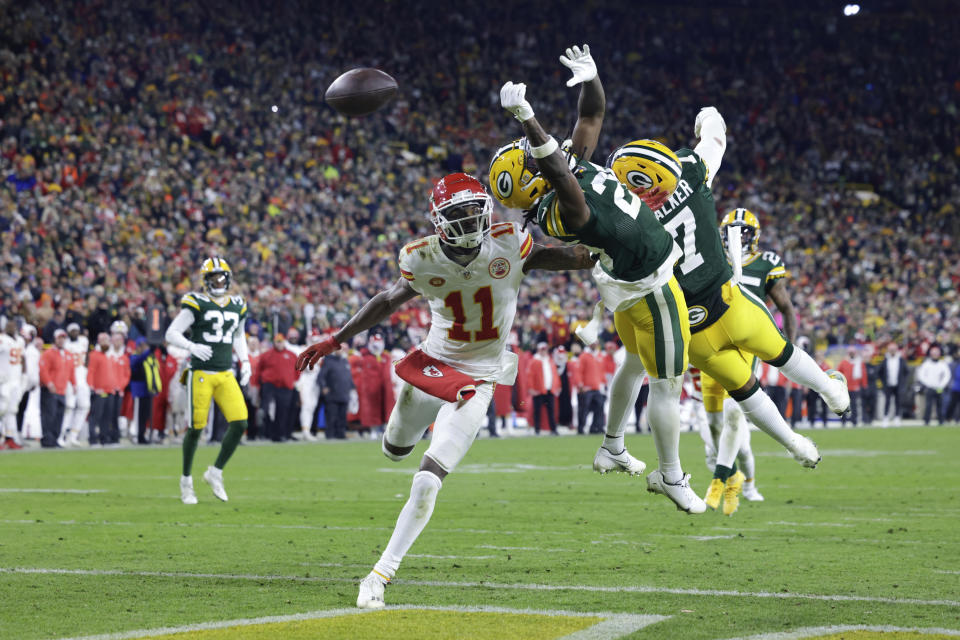 Green Bay Packers defenders knock the ball from Kansas City Chiefs wide receiver Marquez Valdes-Scantling (11) during the second half of an NFL football game Sunday, Dec. 3, 2023 in Green Bay, Wis. (AP Photo/Mike Roemer)