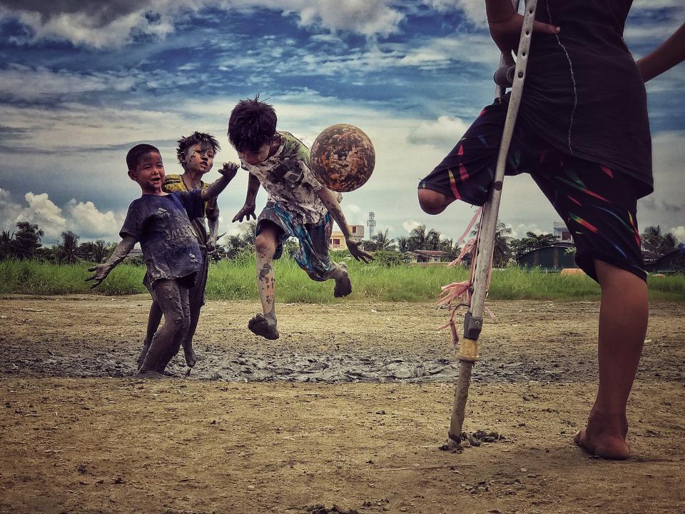 Third Place<br />"I want to play"<br />A young boy who lost his leg was watching his friends play soccer, and he said he wanted to play soccer if he could.&nbsp;<br />Yangon, Myanmar<br />Shot on iPhone 7 Plus