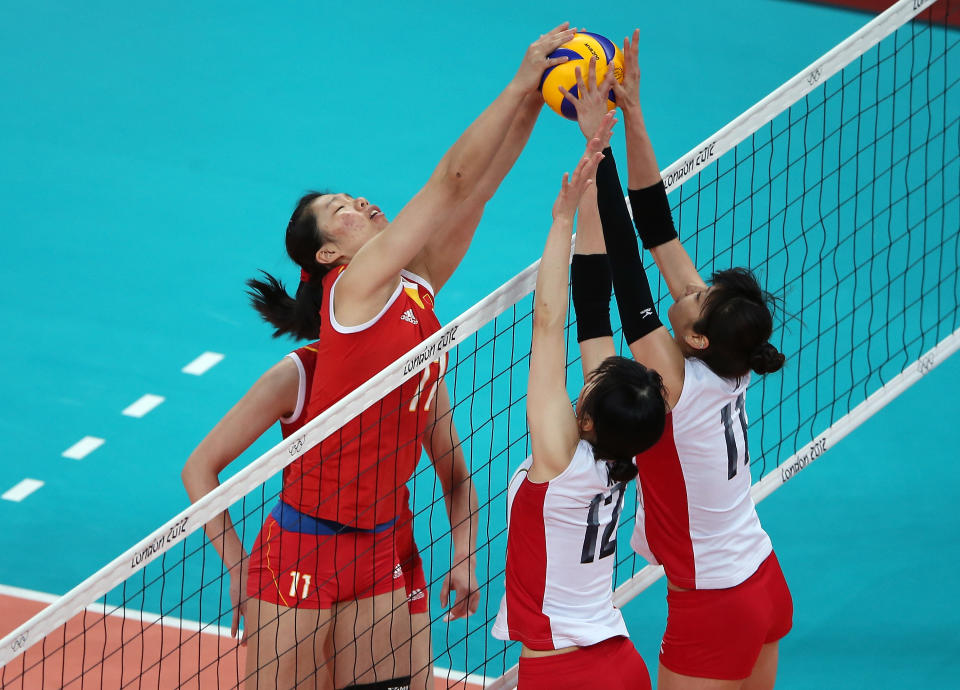 LONDON, ENGLAND - AUGUST 07: Yunli Xu #11 of China tries to get the ball past Ai Otomo #11 and Risa Shinnabe #12 of Japan during Women's Volleyball on Day 11 of the London 2012 Olympic Games at Earls Court on August 7, 2012 in London, England. (Photo by Elsa/Getty Images)