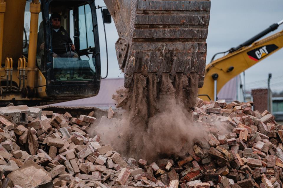 Crews work to clear rubble from the demolition of the former Tuscarawas Valley Brewing Company, Thursday, Jan. 4 in Dover.