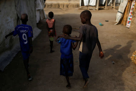 Machiey Mario, 8, Nyameer Mario, 6, Nyawan Mario, 4 and Ruai Mario, 10 (L-R), leave their home on the day they will travel to Juba to be reunited with their mother, in the South Sudan (UNMISS) Protection of Civilian site (CoP), near Bentiu, South Sudan, February 13, 2017. REUTERS/Siegfried Modola