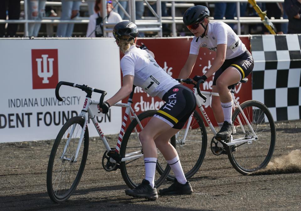 Kappa Alpha Theta’s Claire Tips (left) and Greta Heyl complete an exchange during the 36th running of the women’s Little 500 at Bill Armstrong Stadium on Friday, April 19, 2024.