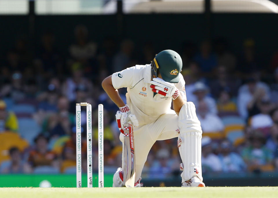 Australia's Joe Burns kneels down after he was bowled out just short of his century by Pakistan's Yasir Shah during their cricket test match in Brisbane, Australia, Friday, Nov. 22, 2019. (AP Photo/Tertius Pickard)