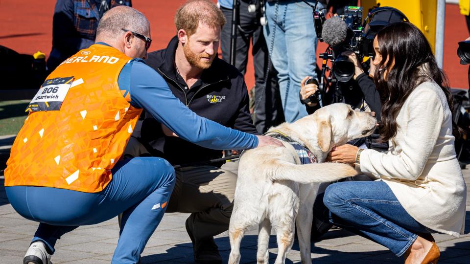 Meghan Markle petting a dog